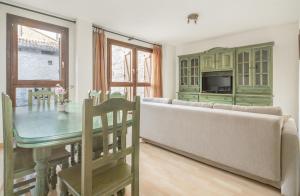 a living room with a couch and a table at Alojamiento Sebastian II Biescas in Biescas
