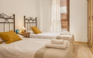 1 dormitorio con 2 camas y toallas. en Alojamiento Sebastian II Biescas, en Biescas