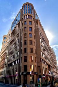 a tall building on the corner of a street at Avenue ApartHotel in Yerevan