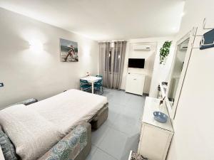 a small room with two beds and a table at Residence Annunziata in Gaeta