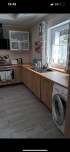 a kitchen with a sink and a washing machine at Przytulny 