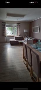 a living room with a bed and a table and chairs at Przytulny in Łęczyca