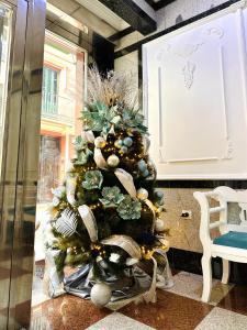 a christmas tree with gold and silver decorations at Hotel Reyesol in Fuengirola