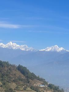 a large body of water with mountains in the background at Nagarkot Resort PVt. Ltd in Nagarkot