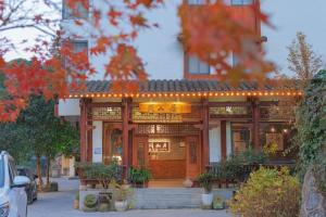 a building with lights on the front of it at Mount View Cottage in Zhangjiajie