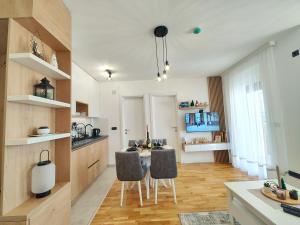 a kitchen with a table and two chairs at Apartman Jović - Zlatni dan - Zlatibor in Zlatibor