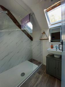 a bathroom with a tub and a sink and a window at Cae Tudur near Barmouth in Barmouth