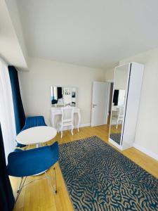 a room with a table and chairs and a mirror at Batumi VIP hotel in Batumi