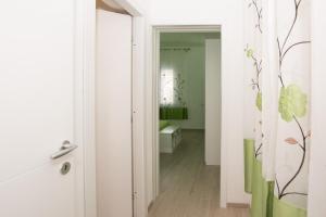 a room with a mirror and a hallway with a bathroom at Affittacamere LE RONDINI in Domus de Maria