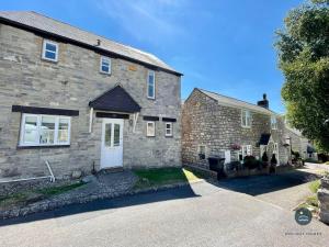 a brick house with a white door and a driveway at Wildflower Cottage - Sutton Poyntz in Preston