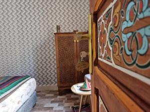 1 dormitorio con 1 cama y 1 mesa con mesa auxiliar en Riad Fes Touria Palace en Fez