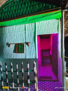 a house made out of legos with pink lights at Tranquil Bambusic Bliss in Kāziranga
