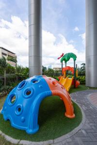 a playground with two play equipment in a park at Lush Residences Makati in Manila