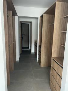 a hallway of a room with wooden cabinets and tile floors at Torre Indico dpto 411 in Mérida