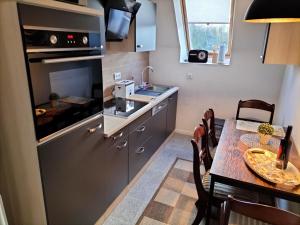 a small kitchen with a table and a dining room at Ferienwohnung Am Ems-Seitenkanal 65353 in Moormerland