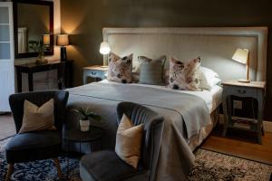 a bedroom with a bed with two cats sitting on it at Elianthe Boutique Guesthouse in Swellendam +116 photos