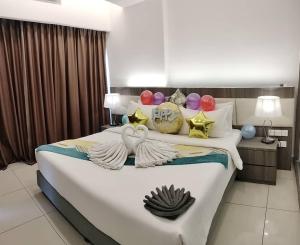 a bedroom with a large bed with decorations on it at Genting Ion Delemen by Horizon Homes in Genting Highlands