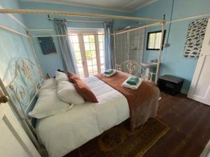 a bedroom with a bed with a metal frame at Port Nolloth Beach Shack in Port Nolloth