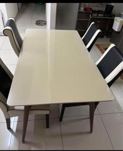 a white table in a kitchen with chairs around it at Bayan Lepas Cozy Family Stay Sea & Airport View in Kampong Batu Maung