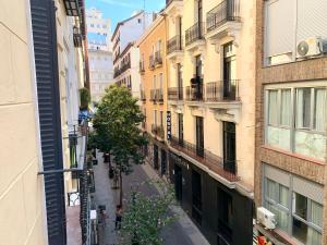 an empty street in a city with buildings at Piso recien reformado, junto a Gran Via in Madrid