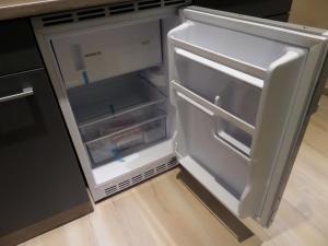 an empty refrigerator with its door open in a kitchen at Main Boardinghouse in Erlenbach am Main