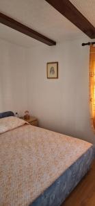 a bedroom with a bed in a room at Apartments Mory in Kornić