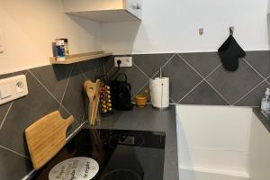 a kitchen with a counter with a guitar on it at "Chez Grâce" in Saintes