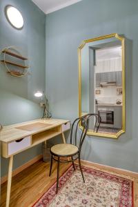 a desk and a chair in a room with a mirror at San Gottardo Suites - Bamboo House in Milan