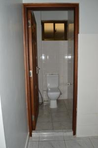 a bathroom with a white toilet in a room at HOTEL TIFFANY in Mombasa