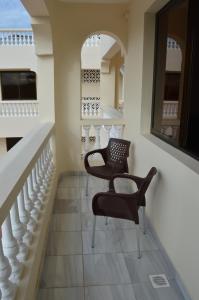a room with two chairs and a staircase at HOTEL TIFFANY in Mombasa