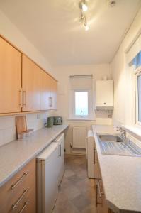 a kitchen with a sink and a counter top at Two Bedroom Flat with Sea Views! in Fife