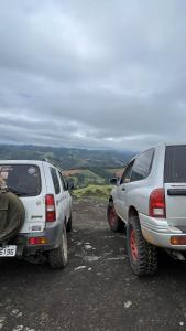 a group of three cars parked on top of a hill at Montanha Home in Monte Verde