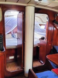 a room with a bed and two windows in a boat at Boat Maeva in Gourbeyre