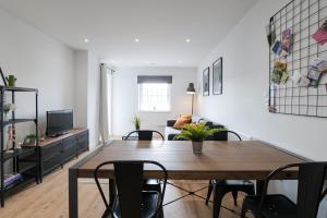 a living room with a wooden table and chairs at Apartments in Cardiff in Cardiff