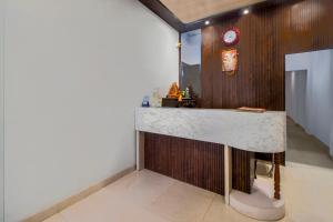 a kitchen with a counter in a room at Itsy By Treebo - Om Pushp Residency in Mathura
