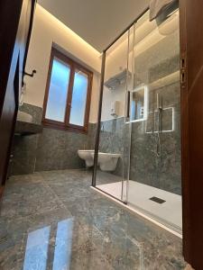 a bathroom with a shower and a toilet and a sink at Hotel Le Due Fontane in Florence