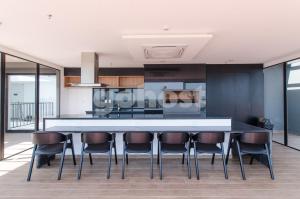 a kitchen with a large island with leather chairs at Distinguished And Elegant Apartment 2 Bedroom in Asuncion