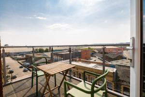 a balcony with a table and chairs and a view of a city at Apartments in Cardiff in Cardiff
