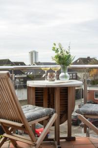 a table and two chairs on a balcony at Villanelle - Spa & Meer in Büsum