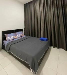a bedroom with a large bed with a black curtain at Bayan Lepas Cozy Family Stay Sea & Airport View in Kampong Batu Maung