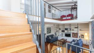 a room with a staircase and a living room at Savelli Suites in Rome