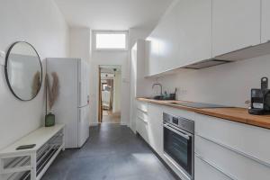 a kitchen with a white refrigerator and a sink at Ruime studio in centrum voor 4 in Ghent