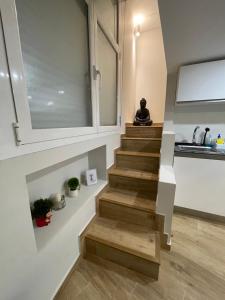 a staircase in a house with a person sitting on the counter at MADRID CENTRO II in Madrid +18 photos