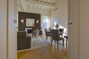 a dining room and living room with a table and chairs at Giotto Suite With View in Florence