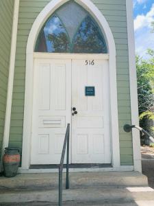 a white front door of a house at The Downtown Abbey in San Marcos
