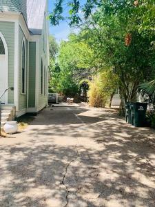 a driveway in front of a house with trees at The Downtown Abbey in San Marcos