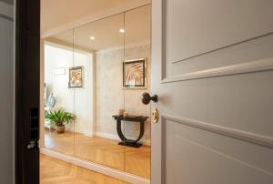 a door leading into a hallway with a mirror at Giotto Suite With View in Florence