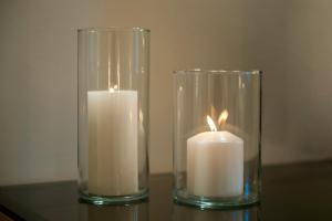 two glass vases with candles on a table at Giotto Suite With View in Florence