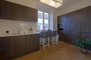 a kitchen with wooden cabinets and a counter top at Giotto Suite With View in Florence