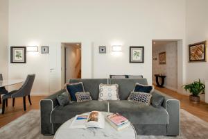 a living room with a couch and a table at Giotto Suite With View in Florence